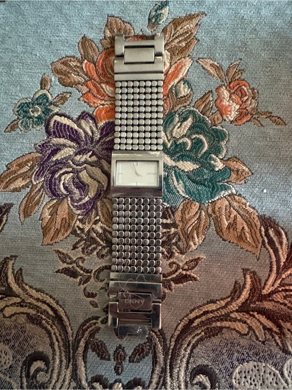 DKNY Women’s Silver-Tone Mesh Link Watch with Rectangular Dial needs battery